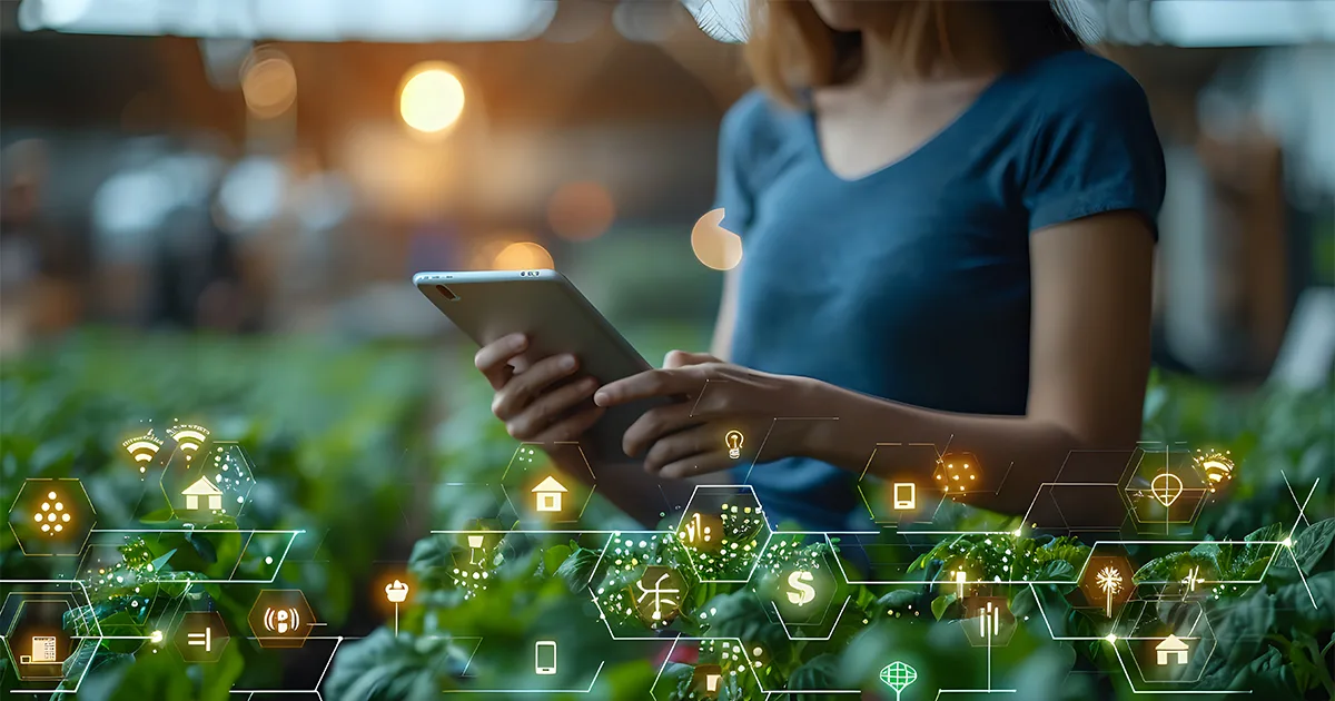 Woman using tablet with agricultural technology in greenhouse